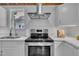 Stainless steel range oven with quartz countertop and white cabinetry at 141 S Broad E St, Angier, NC 27501