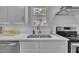 Stainless steel sink with quartz countertop and white cabinetry at 141 S Broad E St, Angier, NC 27501