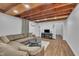 Spacious living room featuring a large sectional sofa and stylish wood-beam ceiling at 141 S Broad E St, Angier, NC 27501
