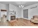 Spacious living room featuring a decorative fireplace, wood floors, and neutral decor at 141 S Broad E St, Angier, NC 27501