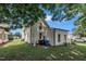 A view of the home's backyard, fence, and surrounding greenery at 141 S Broad E St, Angier, NC 27501