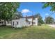 Charming home boasts a spacious backyard, mature trees, and well-maintained lawn at 141 S Broad E St, Angier, NC 27501