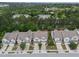 An aerial view showing the neighborhood townhomes with lush trees surrounding the community at 1413 Glenwater Dr, Cary, NC 27519