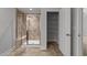 Modern bathroom with a tiled shower featuring a glass door and a built-in bench, with a storage cabinet at 1413 Glenwater Dr, Cary, NC 27519