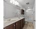 Bathroom featuring a double vanity, large mirror and tub/shower combo with a glass enclosure at 1413 Glenwater Dr, Cary, NC 27519