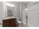 This bathroom includes a glass shower, cherry-wood cabinets and neutral wall paint at 1413 Glenwater Dr, Cary, NC 27519