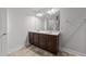 Bathroom with a double sink vanity, a large mirror, and stylish flooring at 1413 Glenwater Dr, Cary, NC 27519