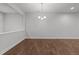 Spacious dining room featuring hardwood floors, neutral walls, and a modern chandelier at 1413 Glenwater Dr, Cary, NC 27519