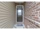 Welcoming front door with glass insert, complemented by brick and siding, for an inviting entryway at 1413 Glenwater Dr, Cary, NC 27519