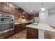 Well-equipped kitchen with a large island, stainless steel appliances, and sleek dark wood cabinetry at 1413 Glenwater Dr, Cary, NC 27519