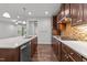 Contemporary kitchen showcasing a center island, stainless steel appliances, and dark wood cabinetry at 1413 Glenwater Dr, Cary, NC 27519