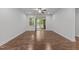 Bright living room with hardwood floors, sliding glass doors leading to a screened porch, and neutral paint at 1413 Glenwater Dr, Cary, NC 27519