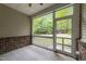 A cozy screened porch features brick accents and offers serene views of the lush backyard at 1413 Glenwater Dr, Cary, NC 27519