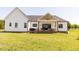Inviting back exterior featuring a covered patio and lush green lawn at 15 Magnolia Ln, Youngsville, NC 27596