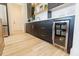Bar area features dark cabinets, white countertops, brass hardware and a beverage refrigerator at 15 Magnolia Ln, Youngsville, NC 27596