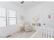 Bright Bedroom with a cozy armchair, crib, stylish decor, and plenty of natural light at 15 Magnolia Ln, Youngsville, NC 27596