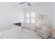 Bright Bedroom with a cozy armchair, crib, stylish decor, and a dresser at 15 Magnolia Ln, Youngsville, NC 27596