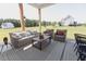 Comfortable covered patio with wicker furniture, perfect for outdoor lounging at 15 Magnolia Ln, Youngsville, NC 27596