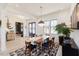 Bright dining room with modern lighting, six chairs, and black framed windows; plants throughout at 15 Magnolia Ln, Youngsville, NC 27596