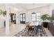 Light-filled dining room featuring a geometric rug, six chairs, and modern black-framed windows at 15 Magnolia Ln, Youngsville, NC 27596