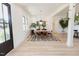 Bright dining room with modern light fixture, seating for six, and stylish geometric-patterned rug at 15 Magnolia Ln, Youngsville, NC 27596