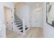Bright foyer showcases stairs with wooden handrail and iron balusters, and neutral walls at 15 Magnolia Ln, Youngsville, NC 27596