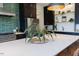 Modern kitchen with a large island, green backsplash, stainless steel appliances and dark cabinetry at 15 Magnolia Ln, Youngsville, NC 27596