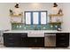 Modern kitchen with farmhouse sink, open shelving, and stainless steel appliances at 15 Magnolia Ln, Youngsville, NC 27596