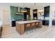Bright kitchen features a large island, stainless steel appliances, stylish pendant lights, and green tile backsplash at 15 Magnolia Ln, Youngsville, NC 27596