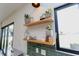 Bright kitchen featuring open shelving and decorative plants at 15 Magnolia Ln, Youngsville, NC 27596