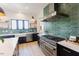 Gourmet kitchen with stainless steel appliances, subway tile backsplash, and ample counter space at 15 Magnolia Ln, Youngsville, NC 27596