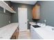 Well-equipped laundry room with modern appliances and storage at 15 Magnolia Ln, Youngsville, NC 27596