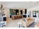 Open-concept living room and kitchen with a large island and leather couch at 15 Magnolia Ln, Youngsville, NC 27596
