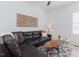 Cozy living room with leather couch, patterned rug, and decorative art at 15 Magnolia Ln, Youngsville, NC 27596