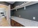 The spacious mudroom features granite counters, cabinets, and decor that adds character and storage at 15 Magnolia Ln, Youngsville, NC 27596