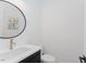 Well-lit powder room with a modern sink, sleek faucet, and decorative artwork at 15 Magnolia Ln, Youngsville, NC 27596