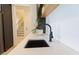 Wet bar featuring quartz countertop, black sink basin, matte black faucet, and open shelf at 15 Magnolia Ln, Youngsville, NC 27596