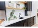 Wet bar area with a sink, open shelving, and beverage fridge for convenience at 15 Magnolia Ln, Youngsville, NC 27596