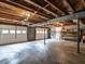 Spacious basement with exposed ceiling beams and multiple garage doors at 1612 Bethlehem Rd, Knightdale, NC 27545
