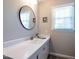 Bathroom featuring a modern mirror, long vanity, and neutral decor at 1612 Bethlehem Rd, Knightdale, NC 27545