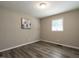 Bedroom with wood-look floors, neutral walls, and natural light at 1612 Bethlehem Rd, Knightdale, NC 27545