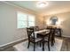 Bright dining room with wood table, seating for six, and natural light from the large window at 1612 Bethlehem Rd, Knightdale, NC 27545