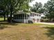 Charming two-story home with a screened-in porch and well-manicured lawn surrounded by mature trees at 1612 Bethlehem Rd, Knightdale, NC 27545