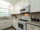 Bright kitchen features white cabinets, stainless steel appliances, and granite countertops at 1612 Bethlehem Rd, Knightdale, NC 27545