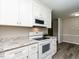 Bright kitchen features white cabinets, stainless steel appliances, and granite countertops at 1612 Bethlehem Rd, Knightdale, NC 27545