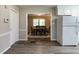 Modern kitchen flows into dining room; showcasing hardwood floors and white appliances at 1612 Bethlehem Rd, Knightdale, NC 27545