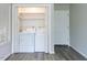 Laundry room with washer and dryer hookups, shelving for storage, and wood-look floors at 1612 Bethlehem Rd, Knightdale, NC 27545