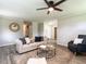 Open living room featuring neutral walls, hardwood floors, ceiling fan and comfortable furniture at 1612 Bethlehem Rd, Knightdale, NC 27545