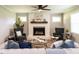 Inviting living room featuring a painted fireplace, hardwood floors, and natural light at 1612 Bethlehem Rd, Knightdale, NC 27545