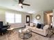 Relaxing living room featuring neutral walls, hardwood floors, ceiling fan and comfortable furniture at 1612 Bethlehem Rd, Knightdale, NC 27545